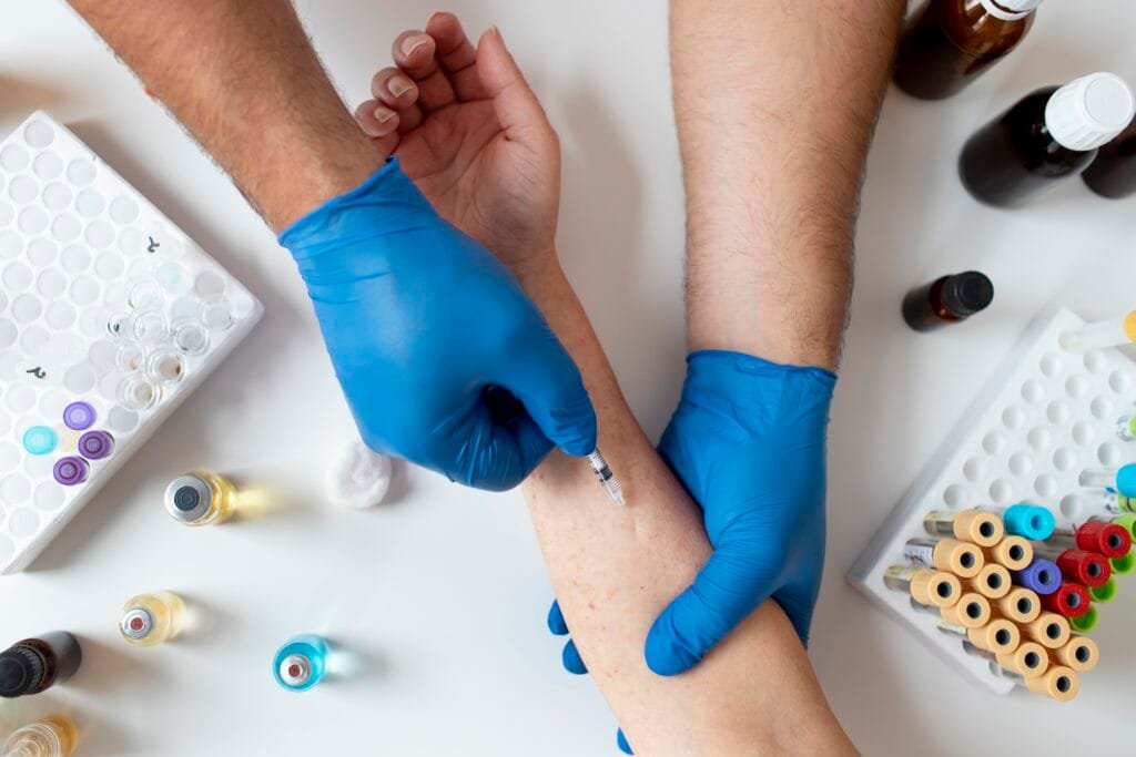 Healthcare professional performing therapeutic phlebotomy in a clinical setting.